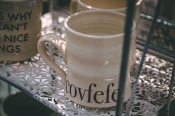 Empty Beige Mug on White Metal Rack
