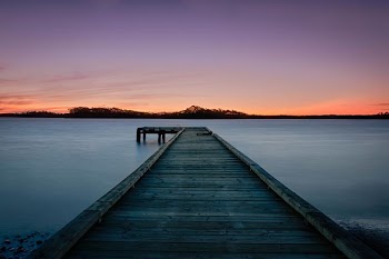 empty bridge along body of water