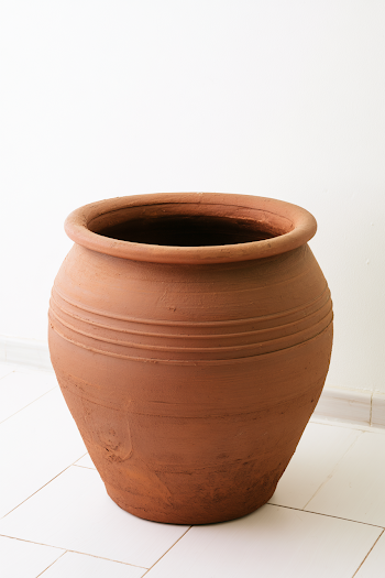 Empty Brown Ceramic Pot on White Floor