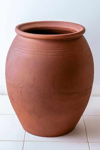 Empty Brown Ceramic Pot on White Floor