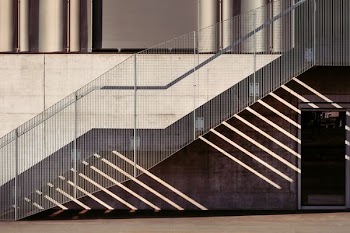 empty gray metal stairs with railings