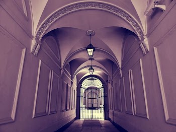 Empty Hallway and Closed Gate