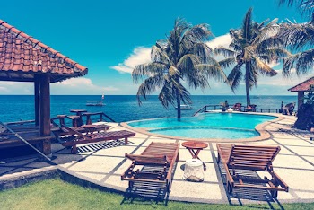 Empty Lounges Near Pool and Ocean