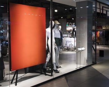 Empty orange sign in clothing store Free Photo