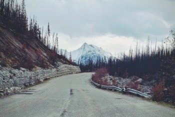 Empty Pave Road Towards Snow Mountain
