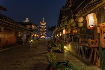 Empty Road Between Brown Wooden Buildings With Chinese Lanterns