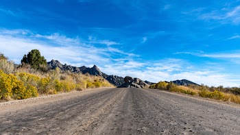Empty Road Under Cirrus Clouds
