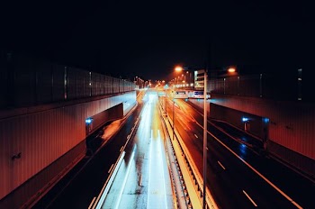 empty road with streaks of light during nighttime time lapse photography