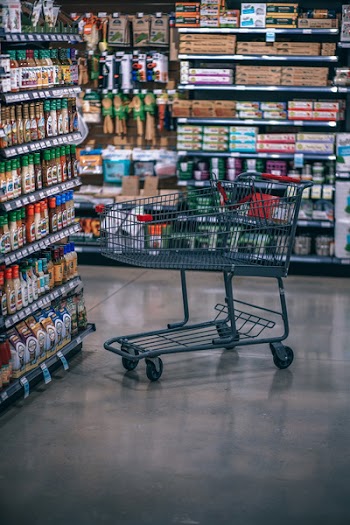Empty Shopping Cart Near Bottles