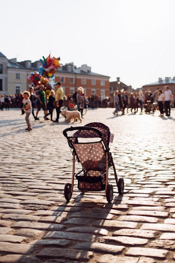 Empty stroller in a crowded Old Town square 2