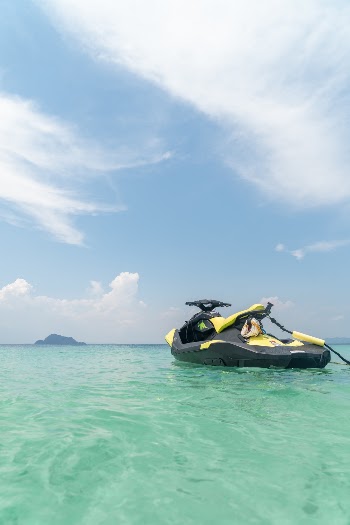 Empty Yellow and Black Jet Ski in Teal Sea Water