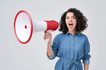 Energetic Young Woman Shouting with Megaphone