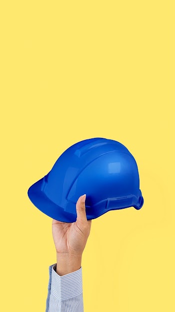 Engineer hard hat held by a hand jobs and… | Free stock photo | High Resolution image