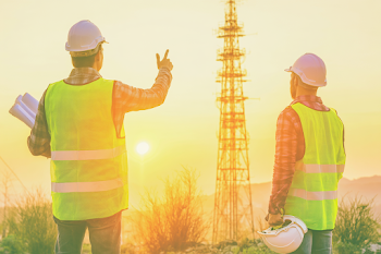 Engineers Planning Construction at Sunset