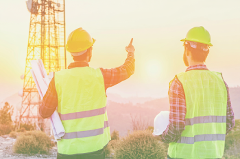 Engineers Planning Tower Construction at Sunset