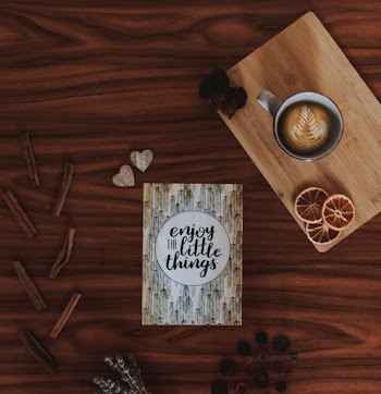 Enjoy Little Things Quote Card on Brown Wooden Surface