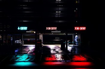 entrance of building with lights on during night time