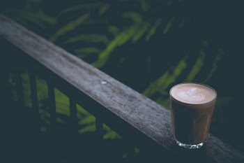 espresso in cup on top of rail