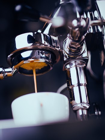 Espresso Machine Extracting Coffee and Dripping in White Cup