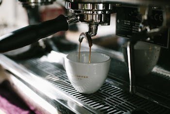 Espresso Machine Pouring White Ceramic Cup