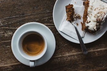 Espresso with carrot cake at a wooden table 