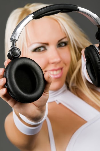Excited blond model in futuristic style clothes with headphones