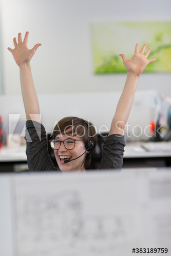 Excited businesswoman celebrating in office