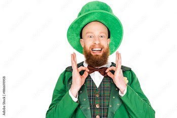 excited man in green leprechaun costume and bow tie, isolated on white
