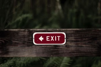 exit signage on wooden plank