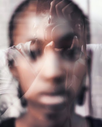 Exploring double exposure through the usage of a window and the camera lens and faces. 