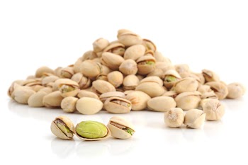 Extreme close-up image of pistachios on white background