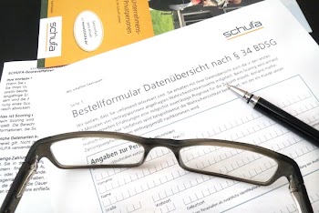 Eyeglasses Beside Black Ballpen