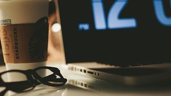 eyeglasses beside laptop computer