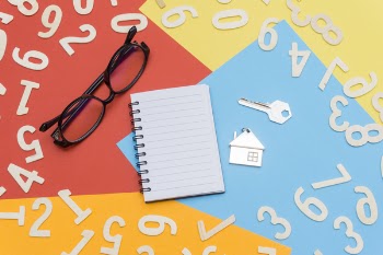 Eyeglasses Near Notebook and Metal Key