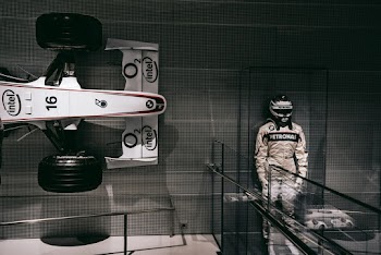 F1 Driver Statue Beside F1 Car