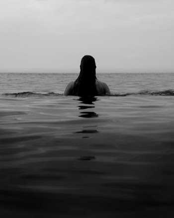 Faceless woman in calm ocean water · Free Stock Photo