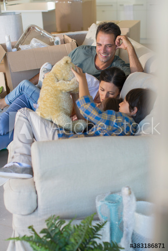 Family on sofa taking a break from unpacking in new house