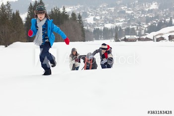 Family running and playing in snowy field