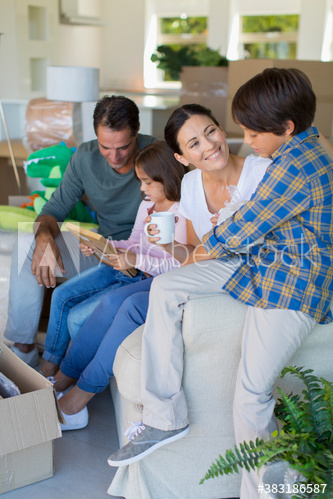 Family unpacking belongings in new house
