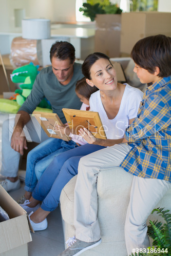 Family unpacking belongings in new house