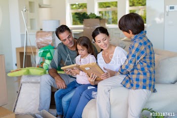 Family unpacking belongings in new house