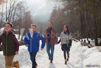 Family walking on snowy footpath
