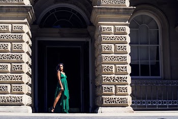 Fashion Model In Green Poses In Archway
