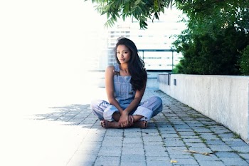 Fashion Model In Overalls Crosses Legs