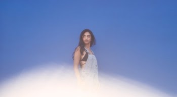 Fashion Model On Blue Wall With Lens Flair