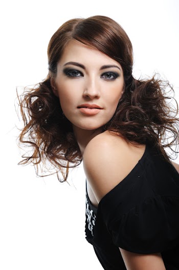 Fashion model with brown curly hairs posing  - isolated on white