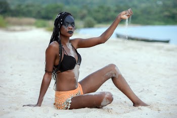 Fashion Photography of Woman Sitting on White Sand White Pouring Sand on Her Hand
