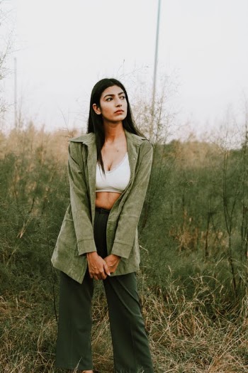 Fashionable young ethnic woman resting in rural field · Free Stock Photo