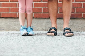 Father and Daughter Stand In Schoolyard