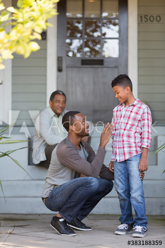 Father and son talking on front stoop